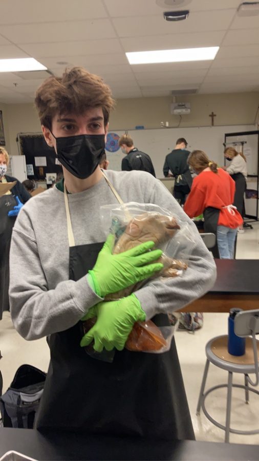 Student Elliot Young holding his pig.